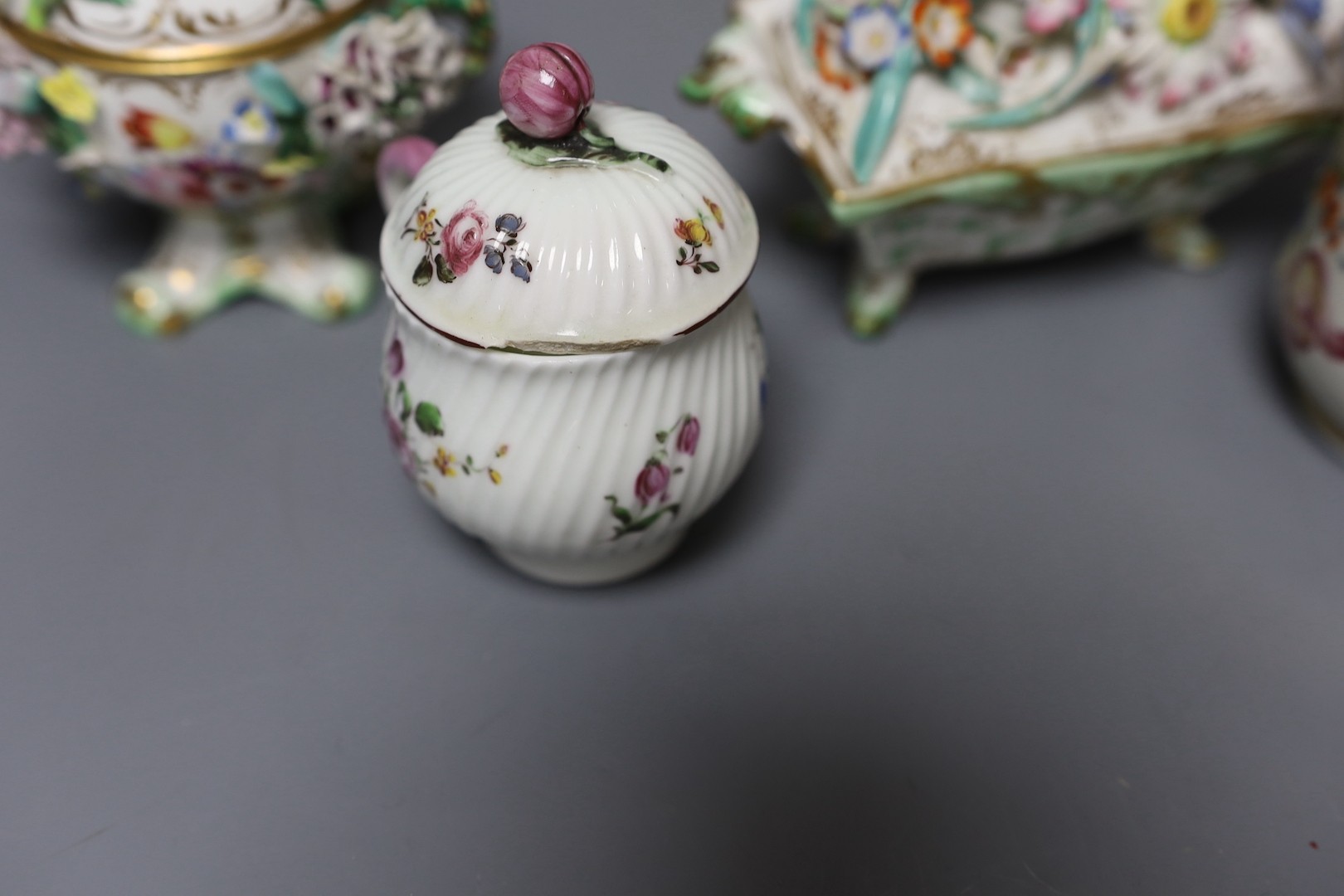 An 18th century Mennecy porcelain cup and cover, a Meissen style cup and cover, an English porcelain floral encrusted double inkwell and cover and a similar jar and cover